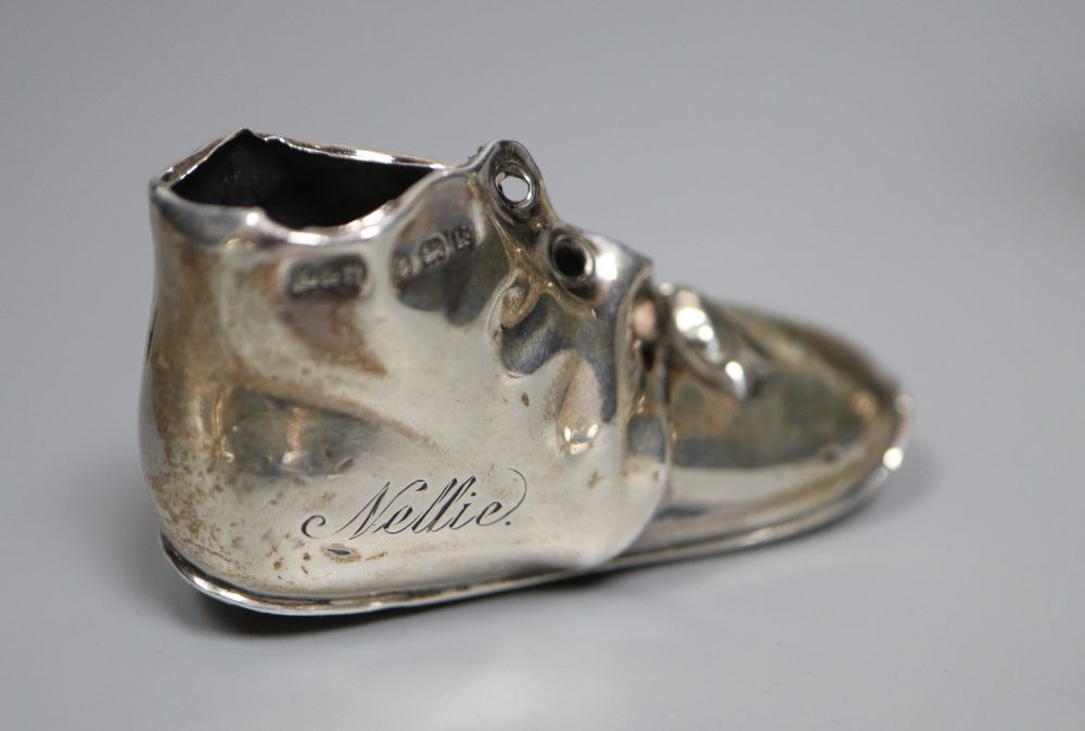 A silver novelty boot pin cushion, Levi & Salaman, Birmingham 1909 (lacking cushion),55m and a plated boot vesta